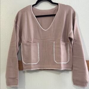 Women's V-Neck Sweater in Rose with decorative white stitching